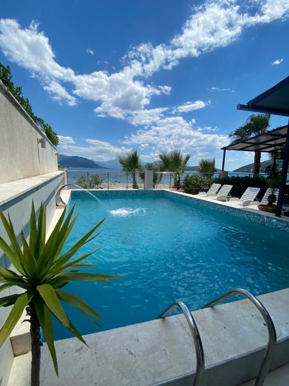 Outdoor swimming pool with a sea view at Hotel Vienna, Igalo